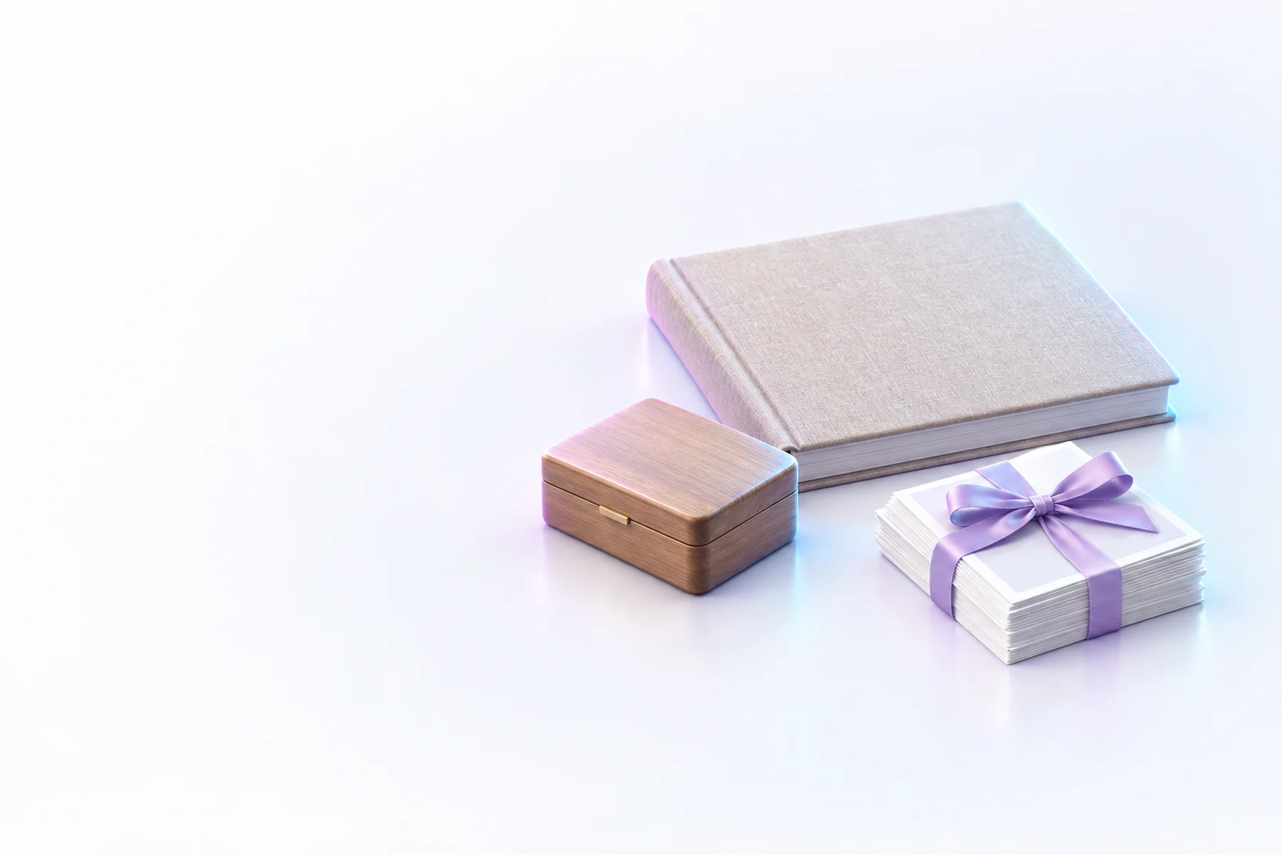 Illustration: a closed linen-covered photo album, a small wooden keepsake box and a stack of blank photo prints tied with a ribbon.